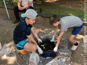 Children making a dinosaur printing casting